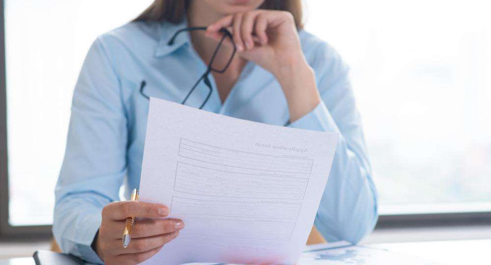Woman reviewing a document at her desk